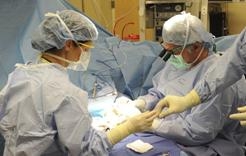 On the job: Dr. Rummel is able to repair knees, elbows and other joints while sitting in his wheelchair. He uses a special standup wheelchair to repair shoulders, which requires the patient to be sitting up