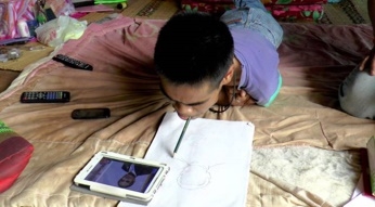 นายลำธาร หรือ ทน จิตอาคะ อายุ 24 ปี กำลังใช้ปากวาดรูปพล.อ.ประยุทธ์ จันทร์โอชา นายกรัฐมนตรี