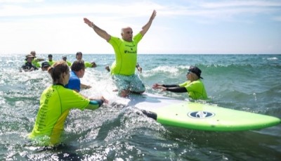 Mohammed Ibrahim, a Syrian refugee with an amputated leg, reacts to catching a wave in the Atlantic Ocean during a surf event for people with disabilities at Martinique Beach Provincial Park in Musquodoboit Harbour, N.S. (Darren Calabrese/Canadian Pr