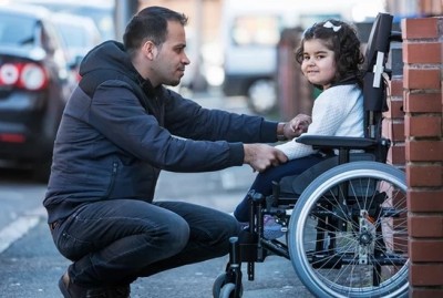 Adnan Omar and his three-year-old daughter Zaynab, who suffers from cerebral palsy and severe epilepsy. Photograph: David Sillitoe for the Guardian