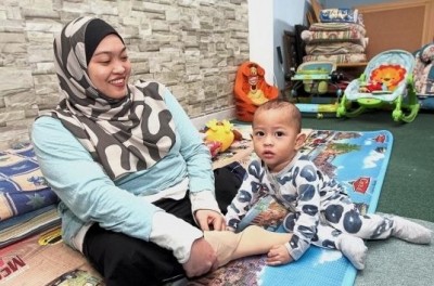 Siti Zuraidah playing her 15-month-old son.